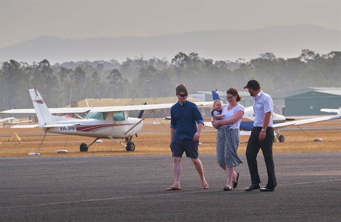 Image of a family walking on the tarmac at Cessnock Airport