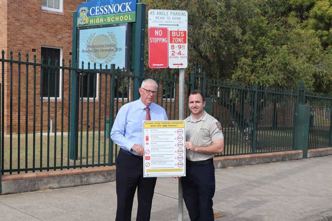 Image of CCC Mayor and Ranger at parking sign