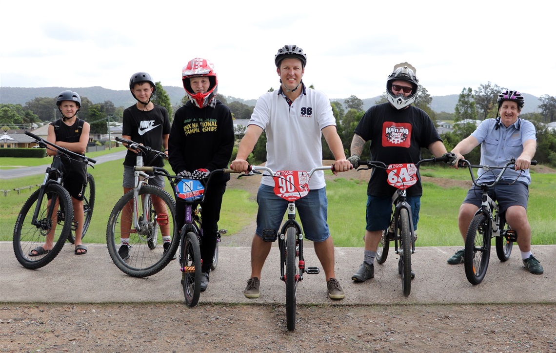 Mayor Suvaal, Steve Whitby from Cessnock Bicycle Company, local champion BMX rider Ella Fairhill, her father Tony Fairhill, and local kids from Bellbird at the existing Carmichael BMX Park