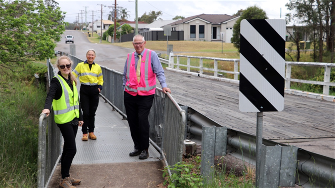 Image of Acting Director of Works and Infrastructure Katrina Kerr, General Manager Lotta Jackson and Cessnock City Mayor Bob Pynsent on the existing bridge.