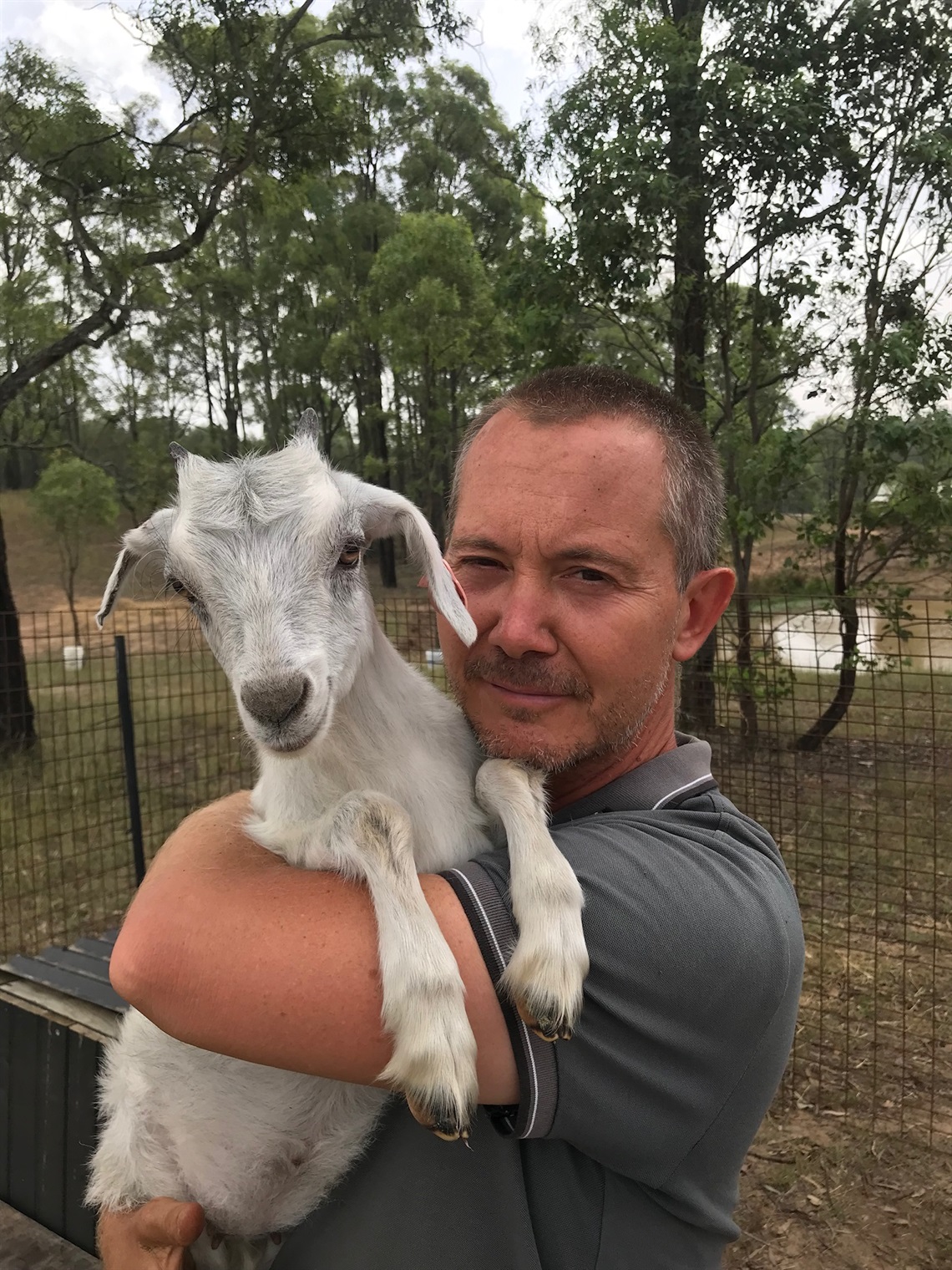 Photo of local author local author Todd Alexander holding a goat.
