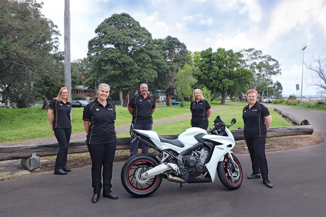 Local Road Safety Officers from participating Councils pictured next to a motorcycle rider