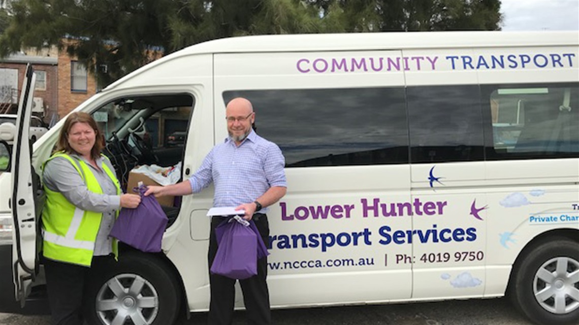 Andrew from our libraries team and  a driver from Lower Hunter Community Transport
