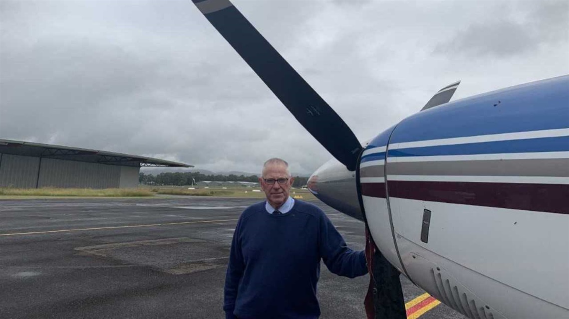 Image of Cr Bob Pynsent next to aircraft