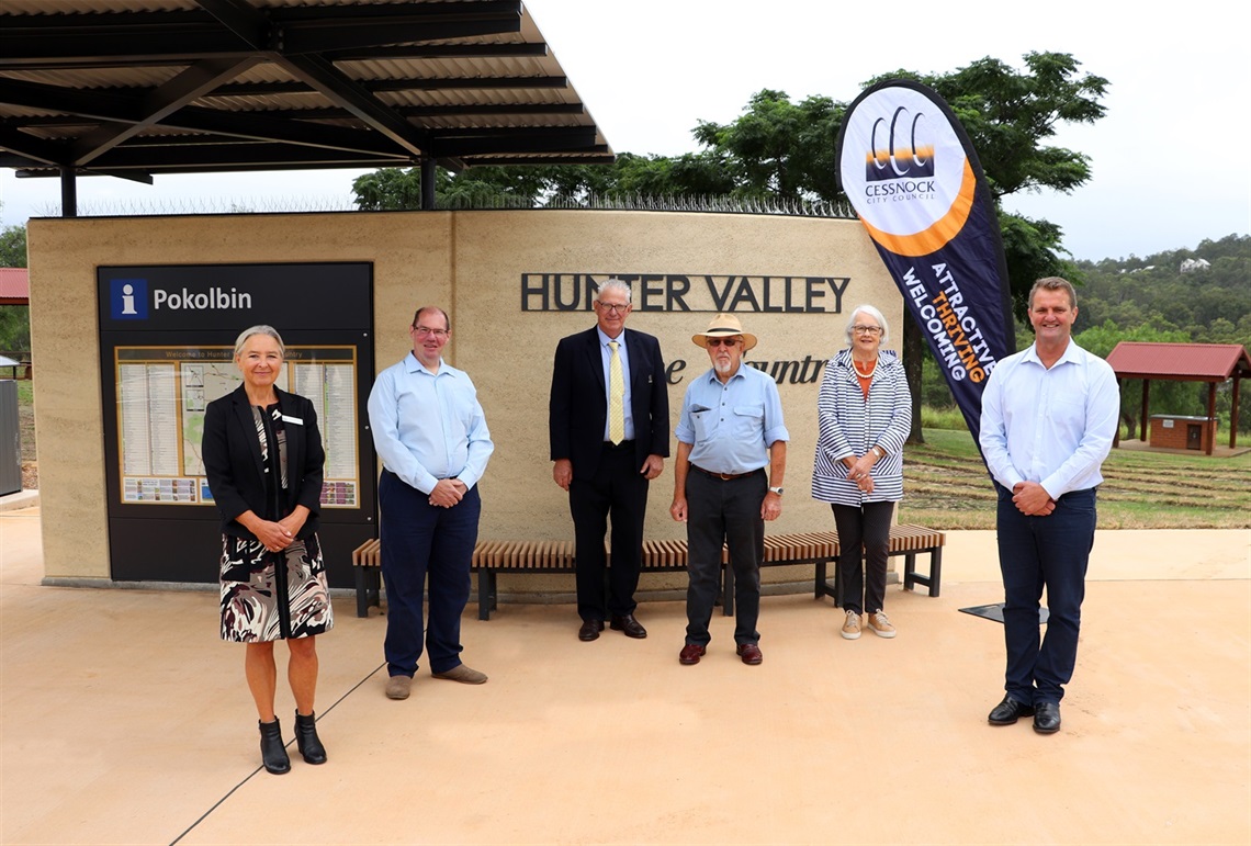 General Manager Lotta Jackson, Councillor Mark Lyons, Jay and Julia Tulloch, Cessnock City Mayor, Cr Bob Pynsent, Member for Cessnock, Clayton Barr MP standing in front of new information bay at Pokolbin Park.