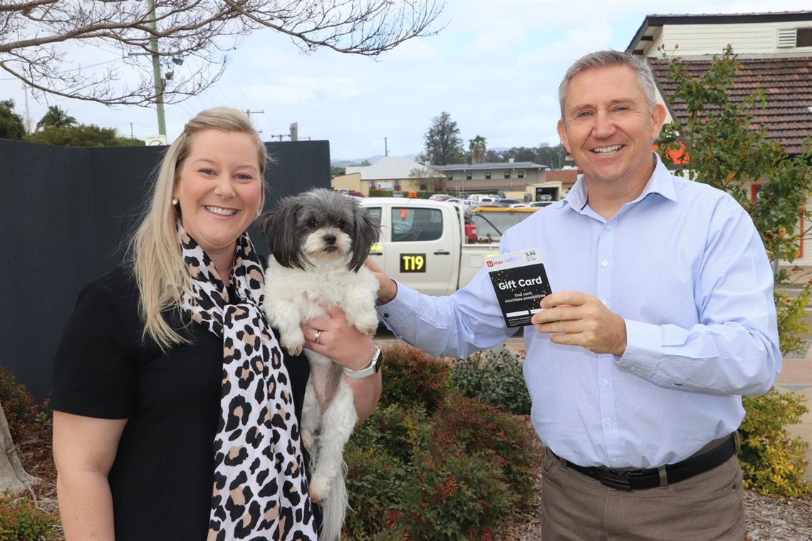 Owner Emily with her winning pooch Olive and Principal Ranger Jason presenting the gift card