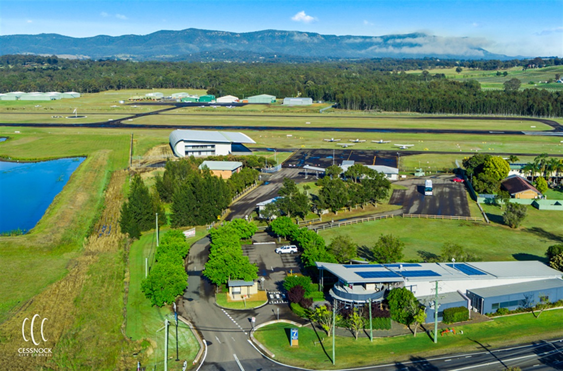 Image is an aerial shot of Cessnock Airport with the Hunter Visitor Information Centre in the foreground.