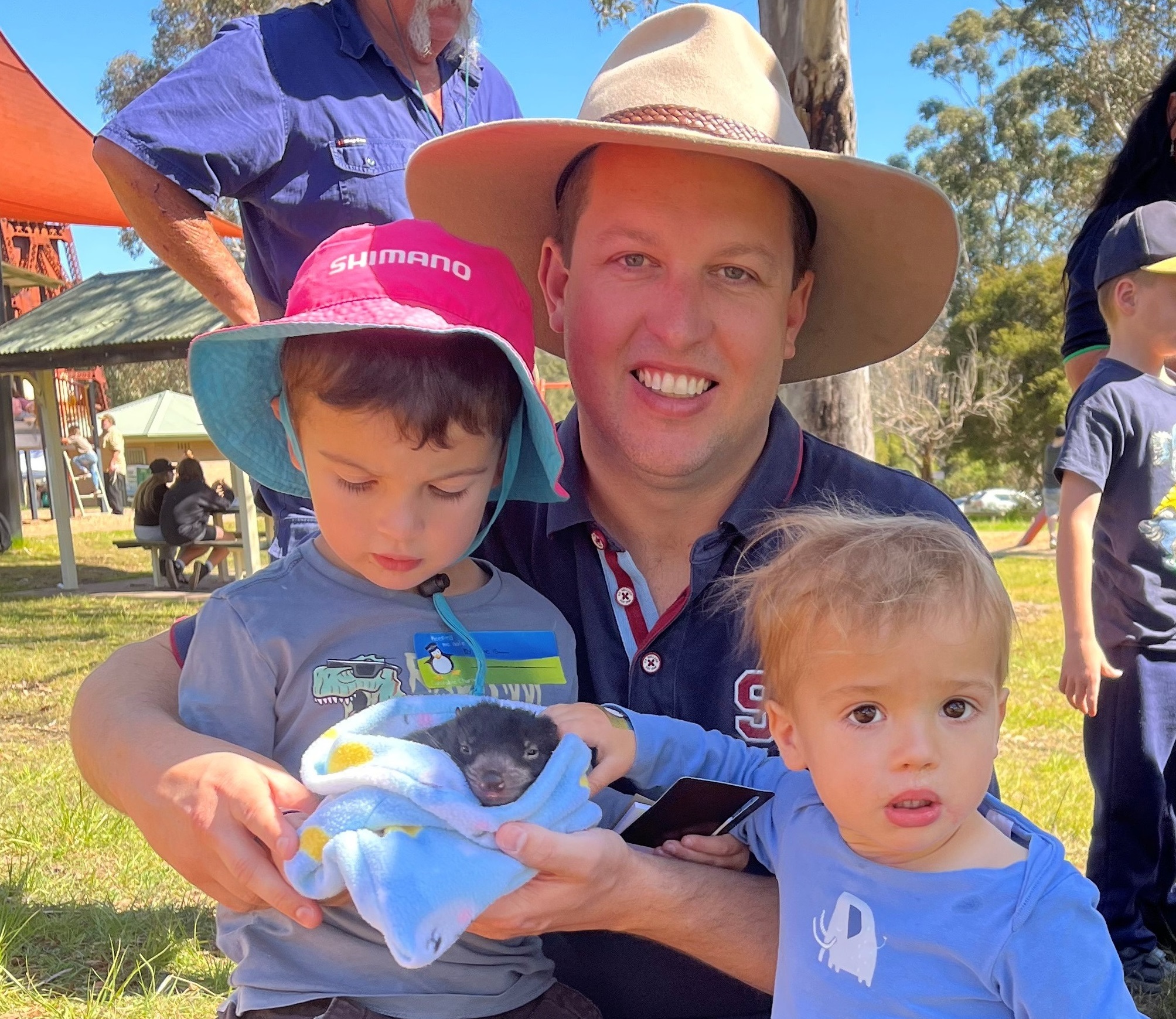 Mayor Suvaal and sons with a Tasmanian devil joey.jpg